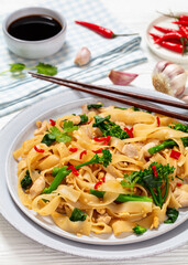 rice noodles with chicken, eggs, chinese broccoli