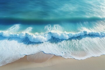 an aerial view of a beach, with the ocean stretching out in a beautiful blue expanse, the shoreline curving along the coast, and the sand sparkling in the sun