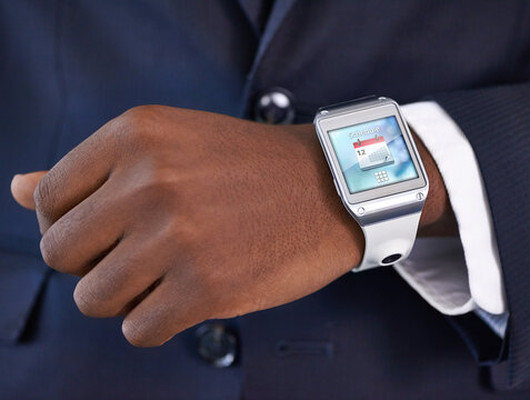 Businessman, hand and smart watch on wrist for digital agenda, online schedule and high tech for job. Black man, arm and suit with future technology for network, screen and check time at work
