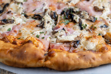 a slice of pizza with mushrooms and meat in sauce