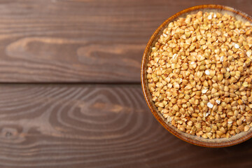 Green buckwheatin  on a wooden kitchen table.Superfood.Raw buckwheat porridge.Healthy vegan food concept, eco products, diet. Copy space.Organic food.weight loss and proper nutrition.