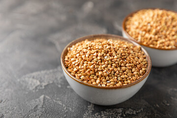 Green buckwheatin  on a wooden kitchen table.Superfood.Raw buckwheat porridge.Healthy vegan food concept, eco products, diet. Copy space.Organic food.weight loss and proper nutrition.