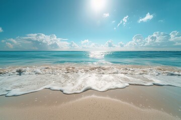 A serene beach scene with waves softly touching the sandy shore under a clear blue sky, inviting relaxation and tranquility