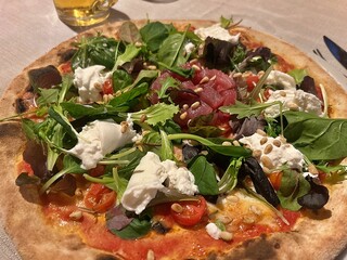 pizza with raw tuna, burrata, pine nuts, salad, tomatoes, modern fresh pizza