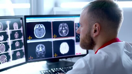 Medical hospital: neurologist use computer, analyze patient's MRI, diagnose brain. Health Clinic Lab: A professional doctor examines a functioning CT scan