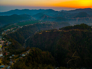 Fototapeta premium Nepal, Balthali, village, twilight, sunset, hills, landscape, aerial view, mountainous terrain, rural, dusk, winding roads, forest, nature, serenity, terraced fields, panoramic view, travel destinatio