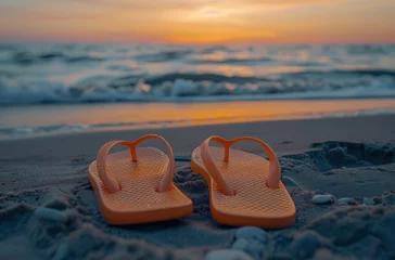Selbstklebende Fototapeten Orange flip flops on the beach at sunset and beautiful sea in the background, summer concept. © Deivison