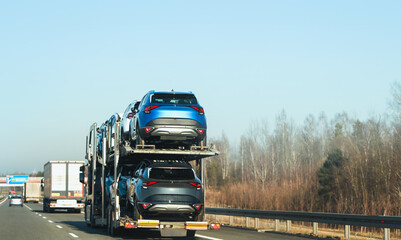 Broken car and towtruck on the highway road.