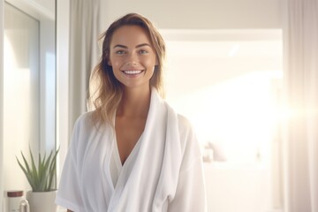 a hotel suite, as a young lady luxuriates in a soft bathrobe, emanating tranquility and relaxation amidst the lavish setting.