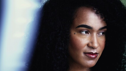 One contemplative black latina woman close-up face gazing in the distance in deep mental...