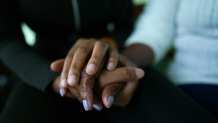 African American Granddaughter holding grandmother's hands and caring embrace showing love and...
