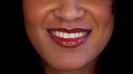 One happy black latina woman close-up mouth smiling in macro detail. Joyful emotion of South American adult girl of African descent wearing red lipstick - obrazy, fototapety, plakaty