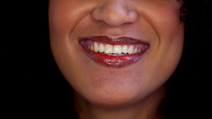 One happy black latina woman close-up mouth smiling in macro detail. Joyful emotion of South...