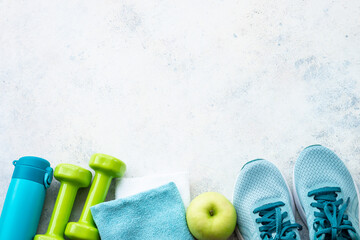 Fitness background, flat lay image. Sneakers, dumbbells and bottle of water. Training, workout and...