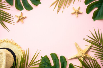Summer composition flat lay. Palm leaves, sea shells, hat and sunglasses on pink background.