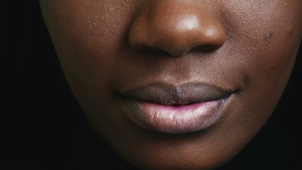 Macro close-up detail of a black girl's mouth and lips. Young woman lip - obrazy, fototapety, plakaty