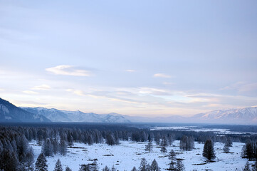 Cold snowy mountain landscape at sunset.