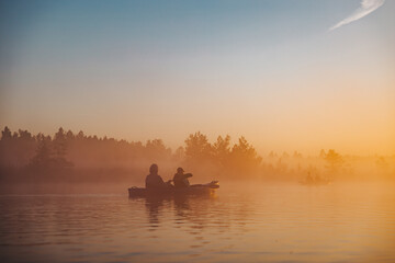 silhouette of two people kayaking in river on sunrise - 757228783