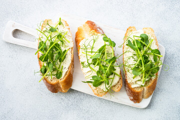 Toast with cream cheese and micro greens. Healthy food, vegetarian, natural vitamins. Top view.