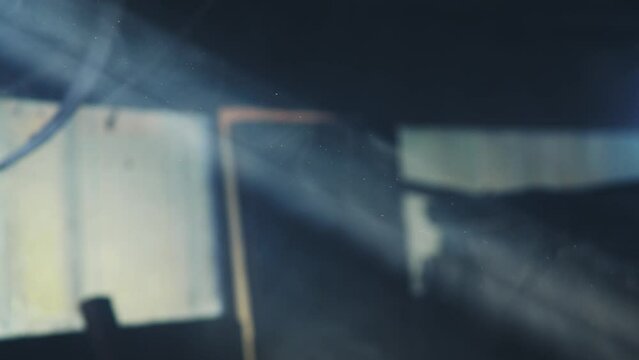 Supernatural bright beam of light fills the screen, the suns rays shine through the cracks, slow motion, camera movement