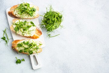 Toast with cream cheese and micro greens. Healthy food, vegetarian, natural vitamins. Top view.