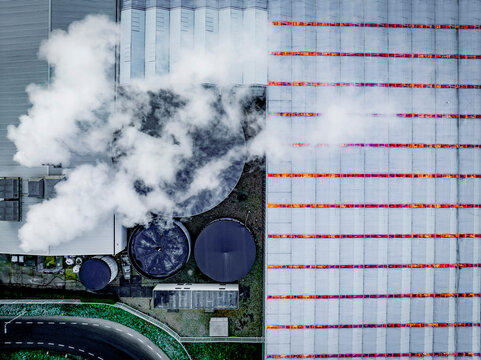 Aerial view of industrial site with steam and colorful containers