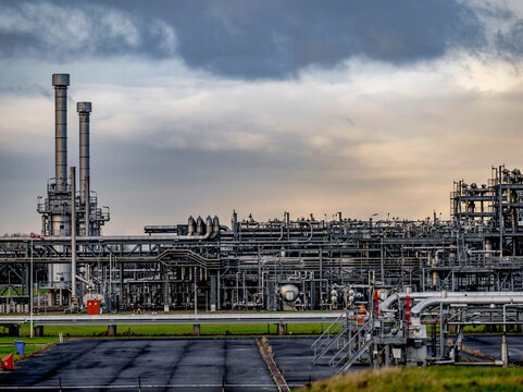 Complex industrial maze under a brooding sky