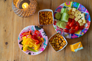 Cozy snack spread on a rustic wooden table with a lit candle.