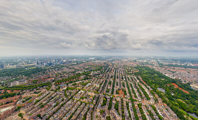 Amsterdam, Netherlands. Panorama of the city on a summer morning in cloudy weather. Aerial view