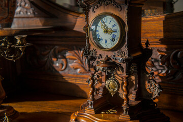 A vintage clock elegantly perched on a polished wooden surface