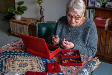 Elderly woman cherishing memories with her jewelry box.