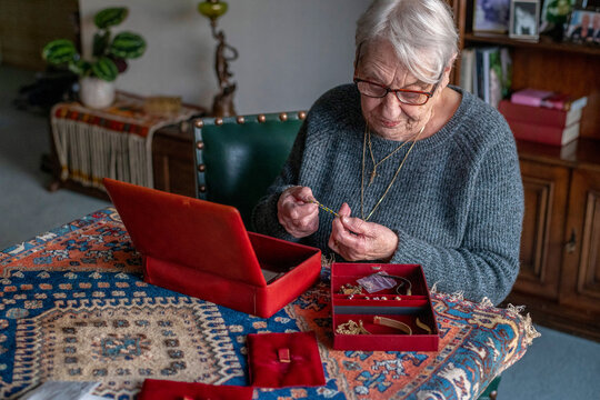 Elderly woman cherishing memories with her jewelry box.