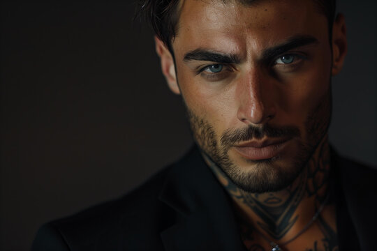 tanned skin, hot and attractive Italian mafia billionaire with a tattoo on his neck , wearing a luxurious black suit. Looking at camera with piercing and sensual gaze
