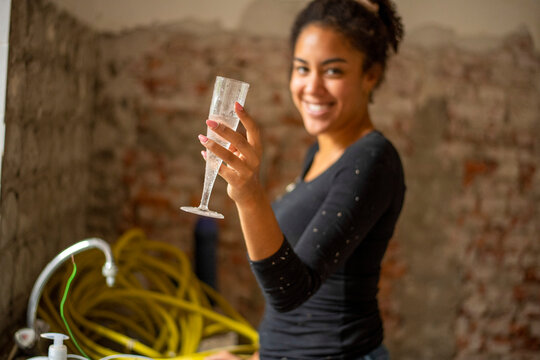 Young woman enjoying a celebratory toast at a casual gathering