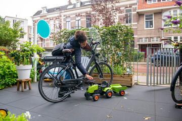 Child parks their bike on a city street