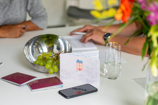 Two individuals engaged in a focused work session at a bright and airy table