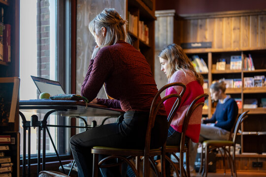 Focused individuals working in a cozy bookstore caf atmosphere