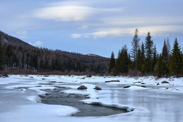 Icy river in a winter wonderland under a cloudy sky
