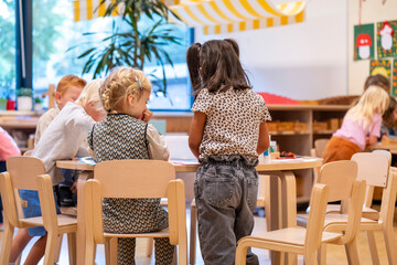 Children engaged in activities at a colorful classroom setting.