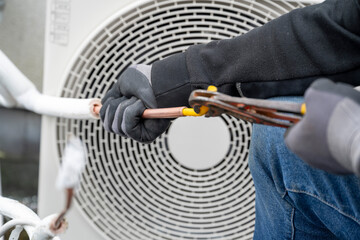 A professional working on HVAC maintenance.