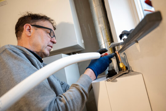 Man working on home plumbing system.