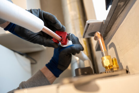 A skilled worker expertly assembles piping infrastructure.