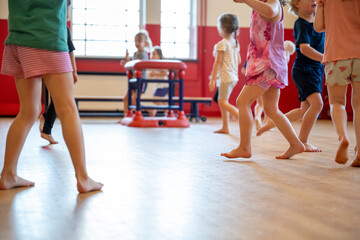 Children enjoying a playful dance session in a colorful classroom.