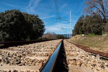 Train tracks where you can see all the details of the railway, cables, towers, rails...
