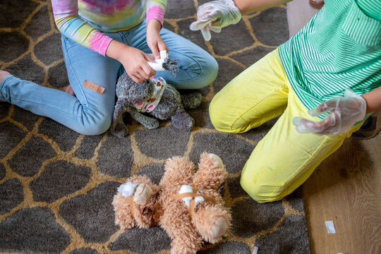 Children playing veterinarian with stuffed animals