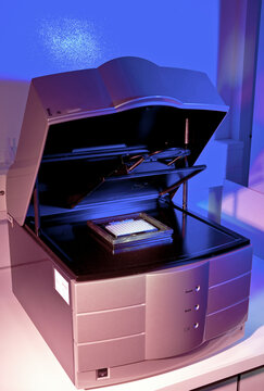 A modern printer under purple-hued lighting
