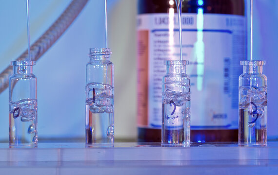 Scientific lab vials bask in a blue glow