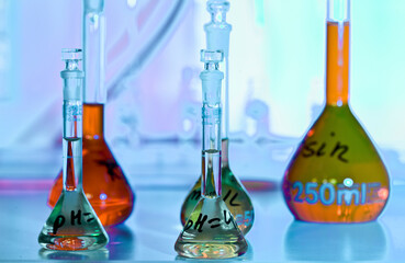 Colorful chemistry glassware illuminated in a science lab
