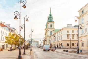 Golden sunrise over a serene European city street.