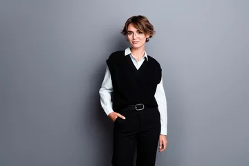 Gordijnen Photo of positive happy lady professor dressed black vest eyewear empty space isolated grey color background © deagreez